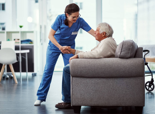 nurse helping senior